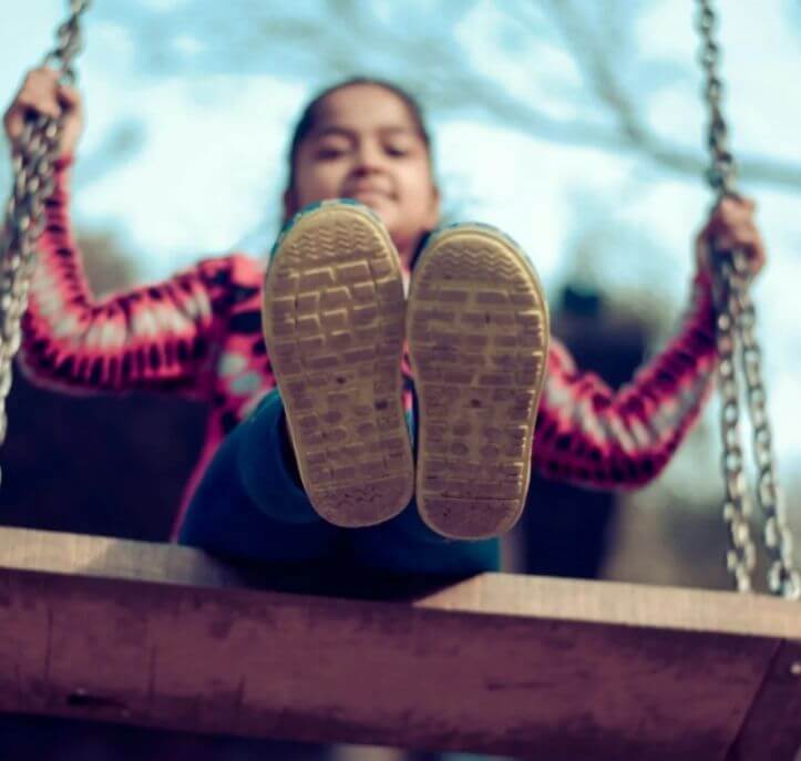 little girl on a swing